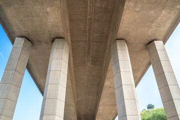 Bottom view of a big concrete bridge with four pillars