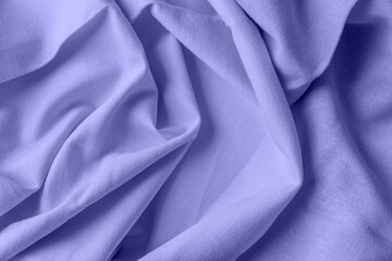 Textured folds of linen fabric in purple color. Textile background, top view, copy space