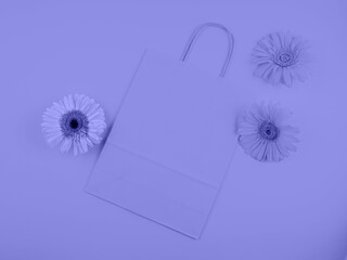 Purple flat paper shopping bag with gerbera daisy flowers