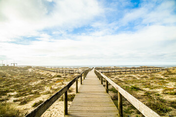 Photo with blue sky and wooden path on Furadouro beach in Portugal