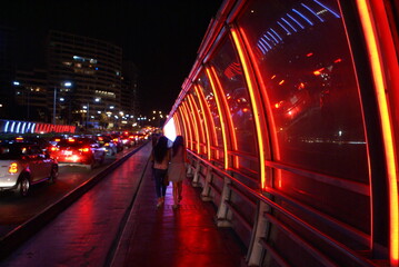 Fototapeta na wymiar Neon street lights up streets in Lima, Peru