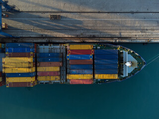 Cargo ship in port loading colorful containers. Maritime transport of merchandise in containers Aerial view of a ship