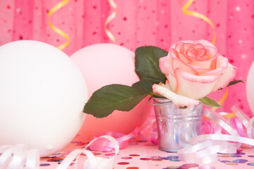 Card with rose flower on beautiful pink background with air balloons