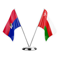 Two table flags isolated on white background 3d illustration, haiti and oman