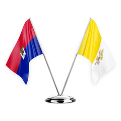 Two table flags isolated on white background 3d illustration, haiti and holy see