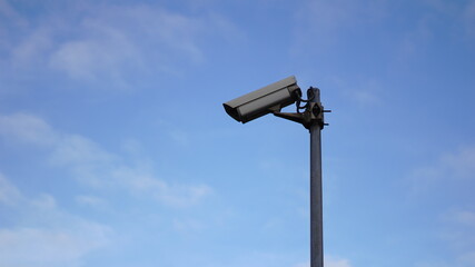 surveillance camera against sky background