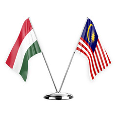 Two table flags isolated on white background 3d illustration, hungary and malaysia