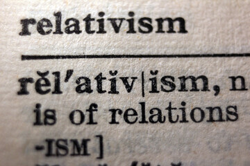 Word "relativism" printed on book page, macro close-up	