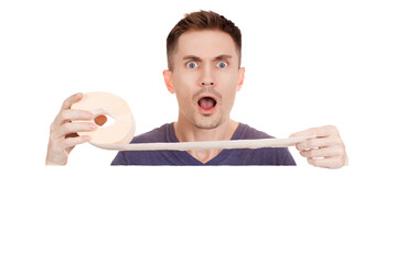 Young guy holding a roll of toilet paper on a white background. Copy space.