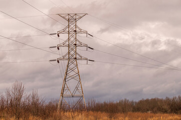 Single high voltage power line tower on a cloudy day, horizontal