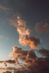 Beautiful clouds in a blue sky with the sun hitting from below in sunset time