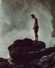 Fitness guy standing in front of a waterfall in Chapada das Mesas National Park, in Brazil