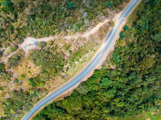High Aerial Of Car Parked Amongst Bushland