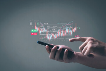 Businessmen work with stock market investments using smartphone to analyze trading data. is showing a growing virtual hologram stock. Financial stock market.