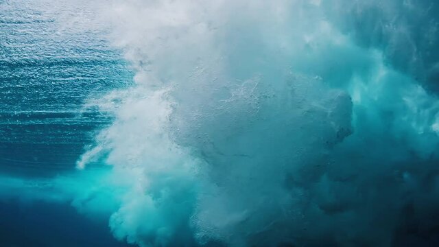Wave vortex with rings. Underwater view of the breaking ocean wave with bubble rings forming with the wave in vortex