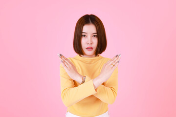 Portrait studio cutout shot Asian young serious moody short hair female model in yellow long sleeve...