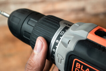 cordless screwdriver drill with battery isolated on white background in close-up detail gripping with one hand 