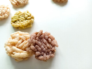 Thai sweets are arranged on white paper background. Thai fried sweet rice. Thai dressert concept.