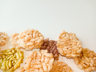 Thai sweets are arranged on white paper background. Thai fried sweet rice. Thai dressert concept.