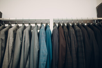 Assorted dark blazers on rack at boutique store
