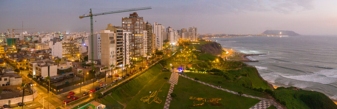 Aerial view of Lima cityscape by shoreline in Peru during evening