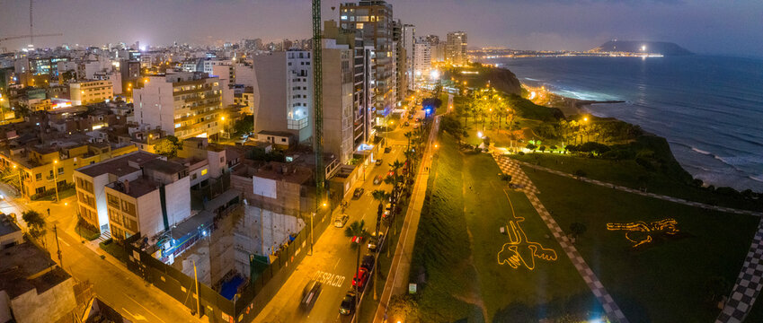 Aerial view of Lima cityscape by shoreline in Peru during evening