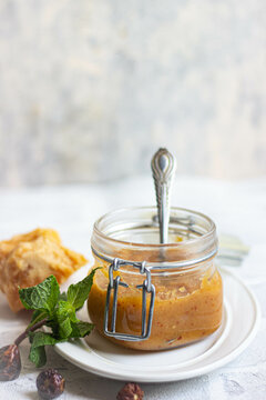 Clear glass jar of yellow jam