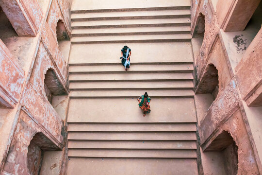 Top view of two girls walking on stepwell in Bara Imambrara,  Lucknow, Uttar Pradesh, India