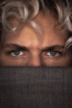 Young man's angry blue eyes