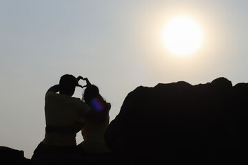 silhouette of a couple watching the sunset