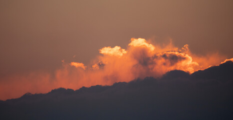 Dramatic sunset, the sun's rays shine through the clouds.