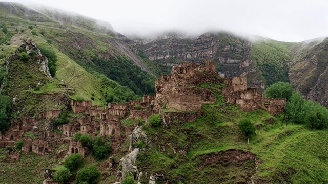 Abandoned in the mountains, the village of Gamsutl. Ghost town, ruins of an old settlement, Impregnable mountain fortress in the Dagestan mountains. Aerial view of an ancient village. 10 bit Video