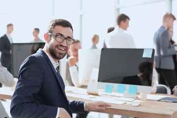 successful business man sitting at office Desk