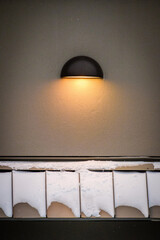 A light on a wall shines down on snow covered walls