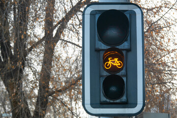 Yellow bike sign on a traffic light for bicycle close-up