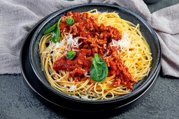 Spaghetti Bolognese on gray background.