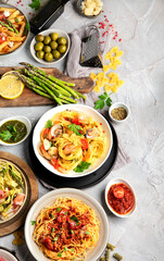 Pasta assortment on gray background.