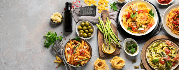 Pasta assortment on gray background.