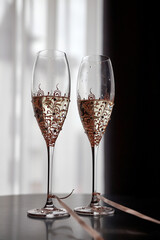 Two glasses of white wine on the table tied with ribbon.