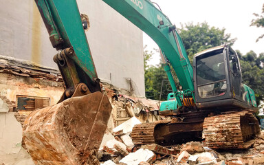 Fototapeta premium Excavators or dumbbells are types of heavy equipment that are generally used to dig soil and move soil or other materials into cargo trucks.