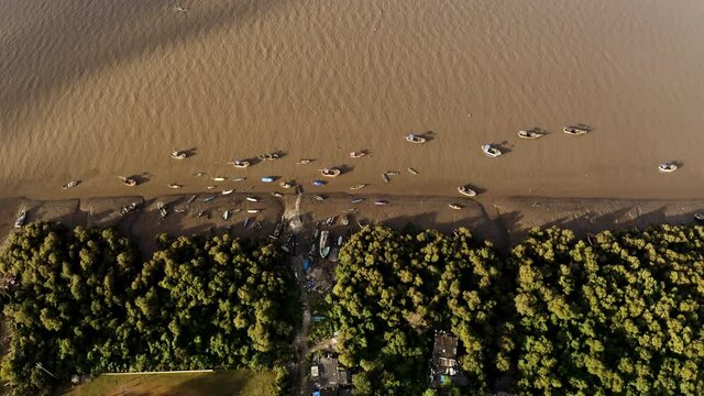 Traditional Boats Moored On Shore Of Bhayandar Khadi Park By Vasai Creek During Low Tide In Mumbai, India. - aerial