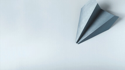 Banner light blue paper airplane on a light background copy space concept.