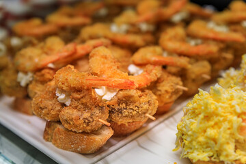 Traditional Spanish pintxos of deep fried shrimp on display in a restaurant, San Sebastian Donostia, Basque Country, Spain