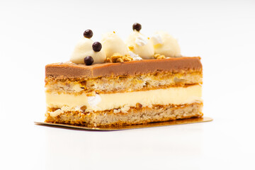 Sweet cake with salted caramel with biscuit layers on white background