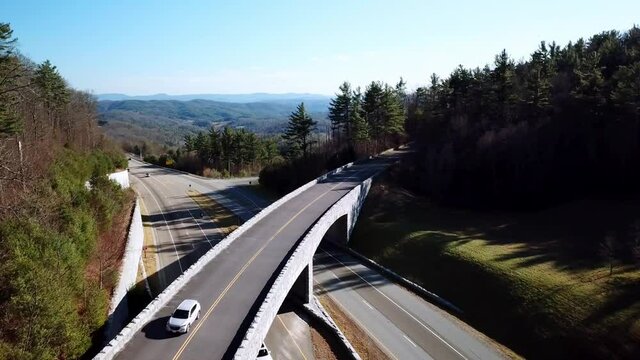 car drives over blue ridge parkway bridge aerial near boone, blowing rock and deep gap nc, north carolina