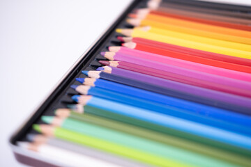 Fototapeta premium Colored pencils in a box on a white background. High quality photo