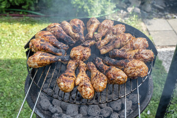 Cooking barbecue chicken wings coal on grill glowing coals bbq in the garden