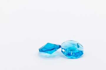 two beautiful blue crystals in plastic on a white background