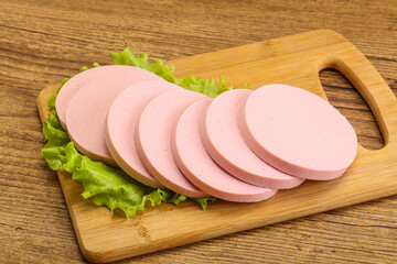 Sliced sausage snak over board © Andrei Starostin