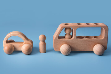 Wooden cars, baby toy for child on blue background. Eco friendly, plastic free toddler kids toys. Educational Montessori learning wooden toys.